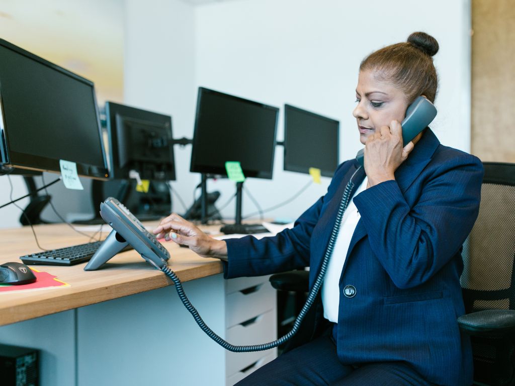 person talking on POTS telephone